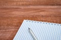 Notebook and pen on the table. A blank sheet of paper and a ballpoint pen. Wooden numbers 2022 Royalty Free Stock Photo