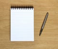 Notebook with pen on wooden desk Royalty Free Stock Photo