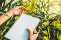 Notebook with pen for writing note postcard.on the background of yellow orchids