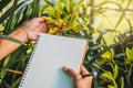 Notebook with pen for writing note postcard.on the background of yellow orchids