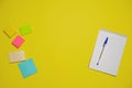 Notebook and pen on a yellow background. Top view with copy space. Stationery Royalty Free Stock Photo