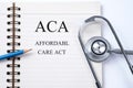 Notebook and pencil with ACA Affordable Care Act on the table