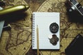 Notebook, pencil, camera, compass, coin, wallet, airplane on blur vintage world map, journey concept, copy space, retro tone