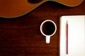 Notebook, pencil and coffee cup with acoustic guitar Royalty Free Stock Photo