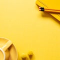 Notebook, pencil, coffee cup on yellow background Royalty Free Stock Photo