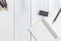 Notebook, pencil and eraser on wooden table, Top view, Concept of workplace, office supplies, background