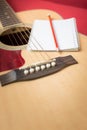 Notebook and pencil on guitar Royalty Free Stock Photo