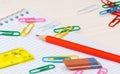 Notebook pencil paper clips on a desk Royalty Free Stock Photo