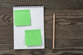 Notebook with pencil and sticky notes on oak wood table Royalty Free Stock Photo