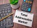 Notebook and pencil with the word Total Addressable Market
