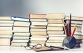 Notebook, pencils, glasses and stack of books, school background for education learning concept Royalty Free Stock Photo