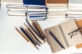 Notebook, pencils, glasses and stack of books, school background for education learning concept Royalty Free Stock Photo