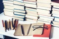 Notebook, pencils, glasses and stack of books, school background for education learning concept Royalty Free Stock Photo