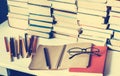 Notebook, pencils, glasses and stack of books, school background for education learning concept Royalty Free Stock Photo