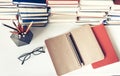 Notebook, pencils, glasses and stack of books, school background for education learning concept Royalty Free Stock Photo