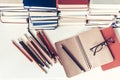 Notebook, pencils, glasses and stack of books, school background for education learning concept Royalty Free Stock Photo