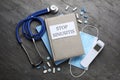 Notebook with phrase STOP SINUSITIS, stethoscope, non-contact thermometer, medical mask and different drugs on grey background,