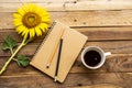 Notebook planner for business work with hot coffee, yellow flowers sunflower