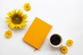 Notebook planner for business work with hot coffee, yellow flowers sunflower, cosmos