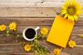 Notebook planner for business work with hot drinks cocoa and yellow flowers cosmos, sunflowers