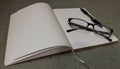 Notebook with reading glasses and pen on top Royalty Free Stock Photo