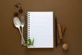 Notebook for recipes, mock up. Open notebook and food condiments, fork and spoon. Anise star, cinnamon sticks, mint Royalty Free Stock Photo