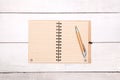 Notebook recycled paper blank on wood table with pen. Royalty Free Stock Photo