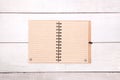 Notebook recycled paper blank on wooden table. Royalty Free Stock Photo