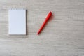 Business still life. Notebook and red pen on the wooden table, top view Royalty Free Stock Photo