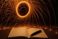 Creative writing session with glowing sparks around an open notebook and pen Royalty Free Stock Photo