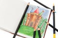 Notebook with a sketch of a fairy castle & pencils