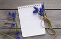 Notebook, spring flowers on wooden background Royalty Free Stock Photo