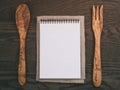 Notebook with spring on wood table with wooden utensils for recipe