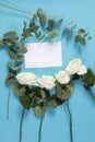 Notebook on the springs with a white rose on a blue background with an empty space for notes. Royalty Free Stock Photo
