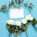 Notebook on the springs with a white rose on a blue background with an empty space for notes. Royalty Free Stock Photo