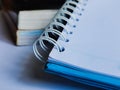 Notebook and stack of books on white background Royalty Free Stock Photo