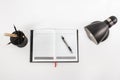 Notebook, table lamp, and stationary at working space