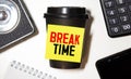 Notebook with text Break time. on table with coffee, calculator and notebook Royalty Free Stock Photo