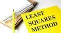 Notebook with the text least squares method on a yellow cover alongside spiral notebooks and a yellow pencil Royalty Free Stock Photo