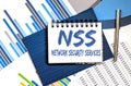 Notebook with text NSS Network Security Services on a chart background