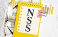 Notebook with text NSS Network Security Services on a chart background