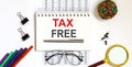 Notebook with text TAX FREE on a table on chart Royalty Free Stock Photo
