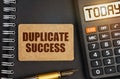 On the notebook there is a calculator with the inscription Today and a sign with the inscription - Duplicate Success