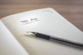 Notebook with a To Do title written by hand and a black pen Royalty Free Stock Photo