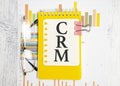 Notebook with Tools and Notes about CRM, concept Royalty Free Stock Photo