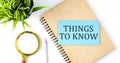 Notebook with Tools and Notes with text on the blue sticker THING TO KNOW Royalty Free Stock Photo