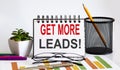 Notebook with Tools and Notes with text Get more leads, business Royalty Free Stock Photo