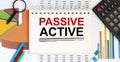Notebook with Tools and Notes with text PASSIVE ACTIVE with chart Royalty Free Stock Photo