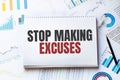 Notebook with Tools and Notes with text STOP MAKING EXCUSES Royalty Free Stock Photo