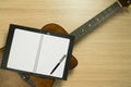 Guitar, Notebook on Wood Background. Royalty Free Stock Photo